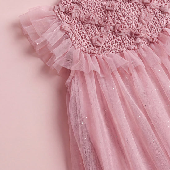 The Primrose pink dress laid flat, showing the crochet yoke and full tulle skirt