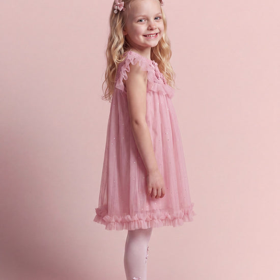 Side view of the Primrose pink dress showing the flutter sleeve and knee length hem