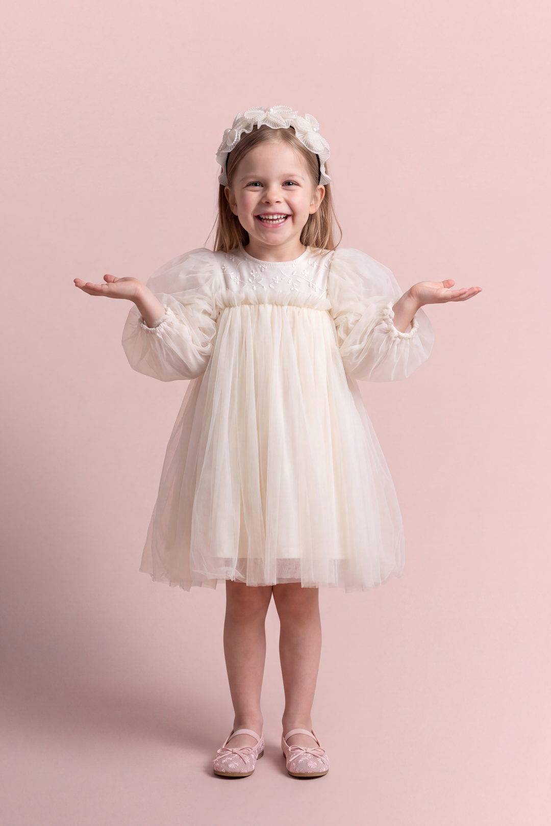 Snowdrop ivory puff sleeve party dress, front view on a girl laughing, embroidered tulle yoke and big puffed sleeves