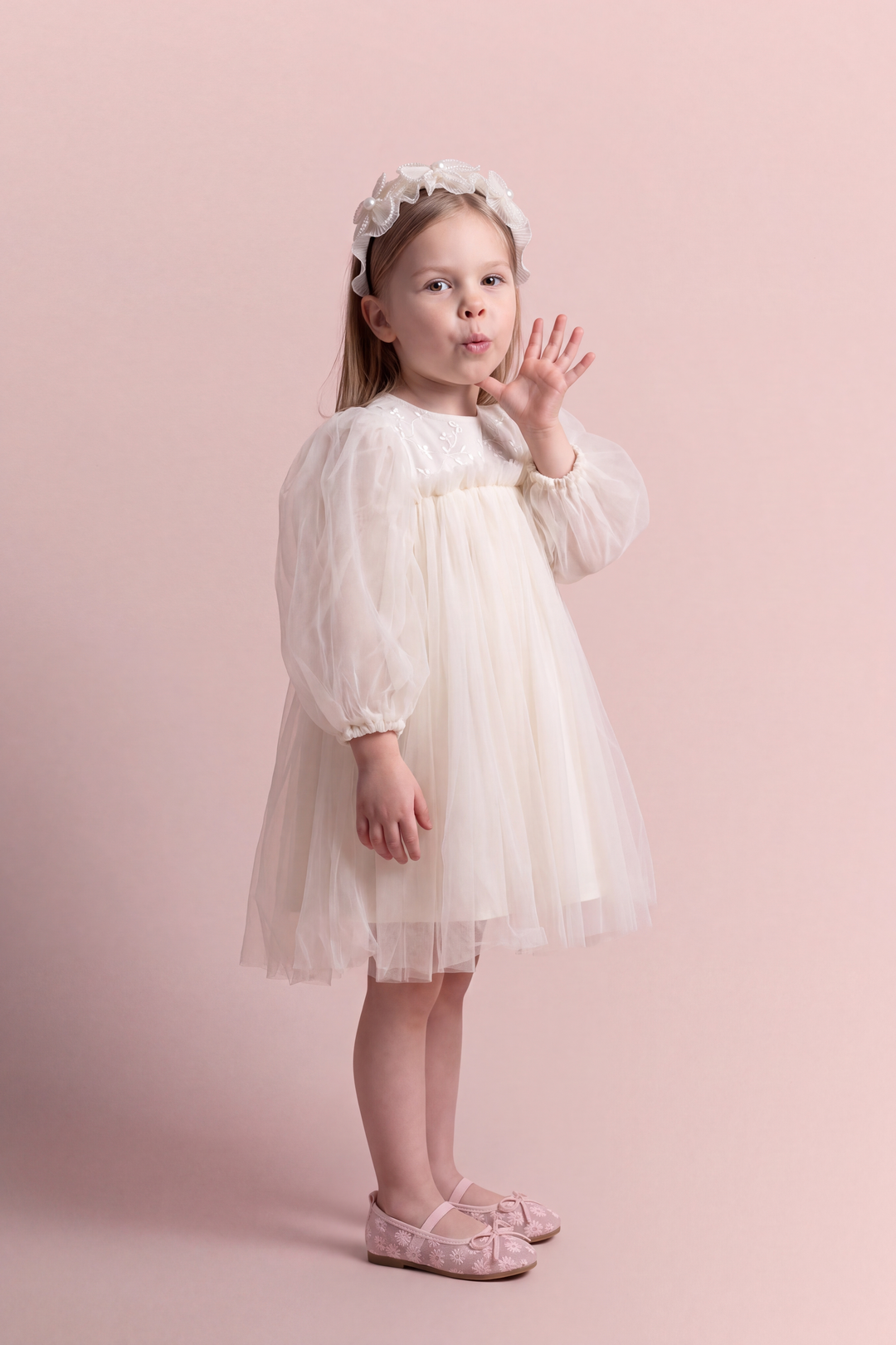 Snowdrop ivory puff sleeve party dress, three quarter view showing the puffed sleeve and the full tulle skirt