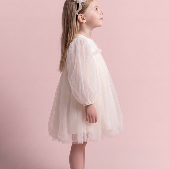 Snowdrop ivory puff sleeve party dress, side view with the sleeve as one soft puff and the skirt standing out