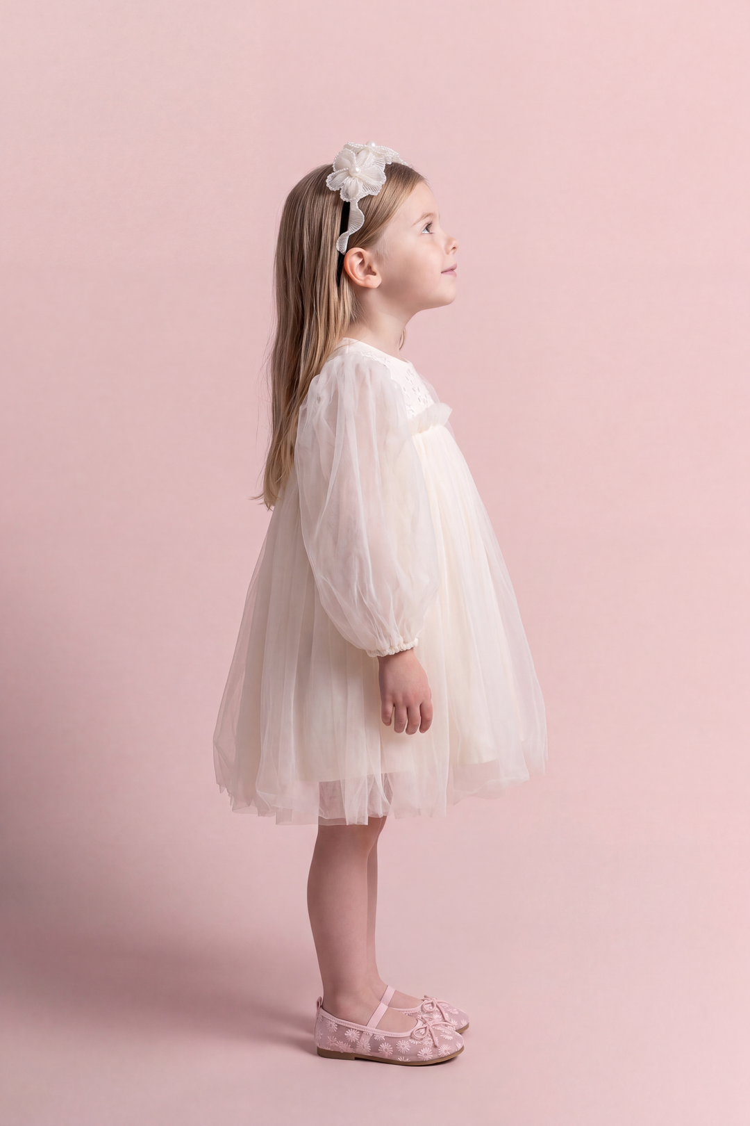 Snowdrop ivory puff sleeve party dress, side view with the sleeve as one soft puff and the skirt standing out