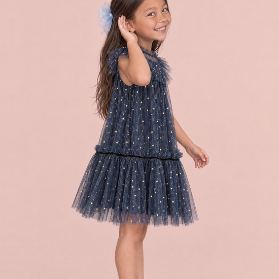 Stardust Navy Star Tulle Party Dress, side view showing the A line shape, the flutter sleeve and the tulle skirt