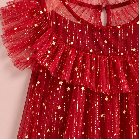 Close up of the gold foil stars and glitter on the red tulle, the ruffle collar and the flutter sleeve