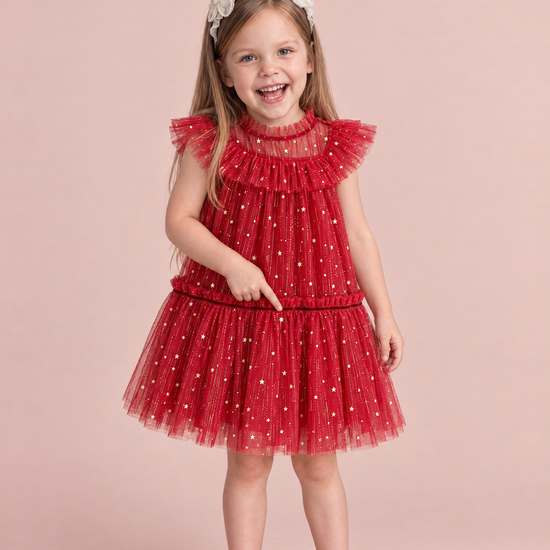Stardust Red Star Tulle Party Dress, front: a girl pointing at a gold star on the skirt of the red tulle dress with flutter sleeves