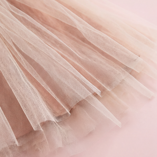 Cream tulle skirt hem over the caramel linen underskirt